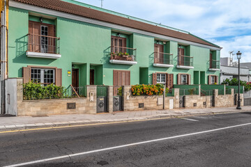 San Cristobal de La Laguna, Spain - November 24, 2021: Green old residential building with balconies on Calle Pedro Zerolo street in La Laguna. Traditional architecture of the Canary Islands