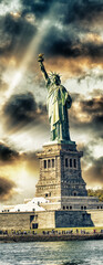 Fototapeta premium New York City, The Statue of Liberty at sunset with a beautiful colorful sky