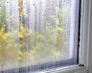 Condensation water on window glass on the inside of the house