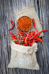 Cayenne pepper and dried red chili on old wooden table background