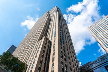 Fototapeta na wymiar Rockefeller Center tower bottom view against blue sky in Manhattan in New York