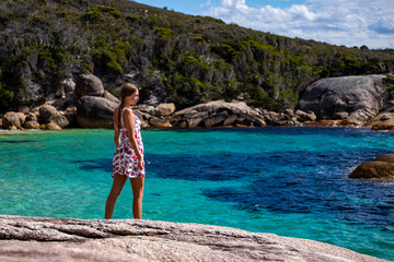 girl in white dress with pigtails on a paradise beach with turquoise water; unique beach in western australia