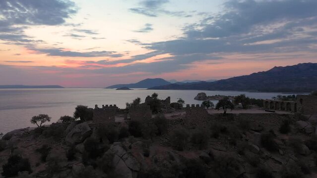 Aerial footage of a lake and islands, top view of bafa lake with sunset light and day time light