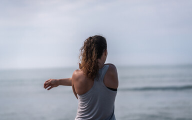 Woman Stretching Right Arm on Beach