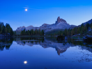 High mountains and reflection on the surface of the lake. Lago Federa, Dolomite Alps, Italy. Landscape at the night. Photo in high resolution.