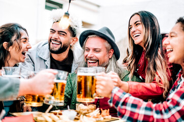 Group of happy friends drinking beer at beer garden bar - Smiling people of different ages partying and clinking beer glasses at happy hour - Friendship lifestyle concept