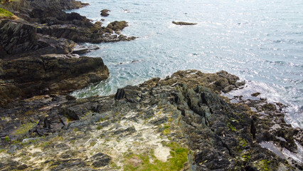 Stone cape of the coast. Rocky seashore in sunny weather. Nature of Europe.
