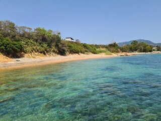 Transparent sea water and rocky bottom near the coast of wild beach