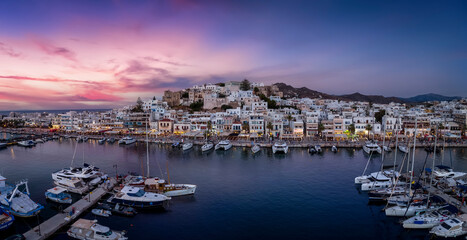 Fototapeta na wymiar Panorama of the city and marina of Naxos island, Cyclades, Greece, during a beautiful summer evening with soft light