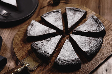 Kladdkaka. Traditional Swedish moist chocolate cake on wooden table. Fika. Hygge. Winter treat - 533445813