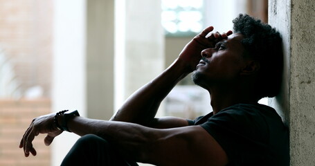 Contemplative African pondering solution to problems. Black person suffering alone