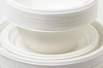 Disposable plastic tableware isolated on white background. Plates made of plastic
