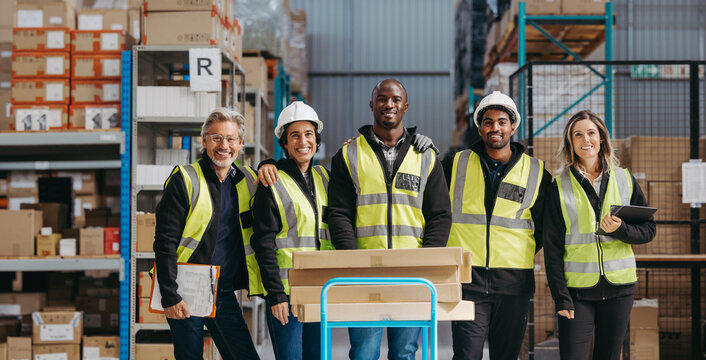 Portrait of a warehouse staff smiling at the camera happily