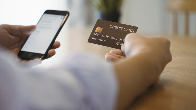 Businessman touch slide smartphone screen and holding credit card in hand using instant easy mobile payments making purchase in online store.