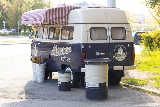 Krasnoyarsk, Russia - September 23, 2022: Mobile coffee shop in brown cozy Bukhanka minibus or UAZ SGR van on city street.