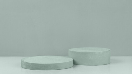 Podium abstract background. Two cylinder plaster podiums on a pastel green background, front view. Geometric shape. Empty showcase for product presentation, pedestal for cosmetic product.