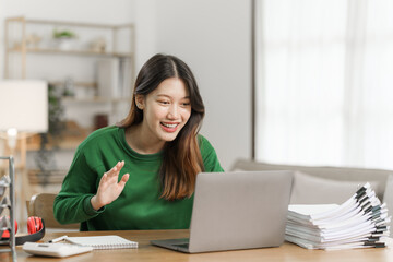 Young cheery happy positive asian woman sit indoors and using laptop, relax time.
