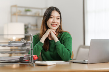 Young cheery happy positive asian woman sit indoors and using laptop, relax time.