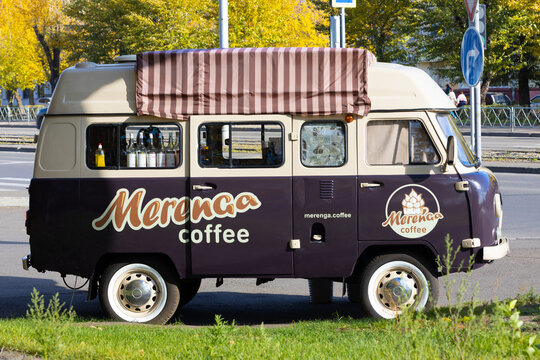 Krasnoyarsk, Russia - September 23, 2022: brown and beige UAZ SGR van or Bukhanka minibus car with mobile coffee shop on city street. Food van truck. Street food business.