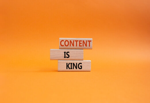 Content is king symbol. Concept words Content is king on wooden blocks. Beautiful orange background. Business and Content is king concept. Copy space.