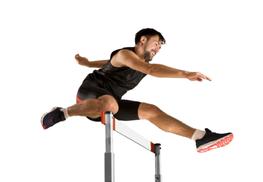 Young male athlete at hurdle race