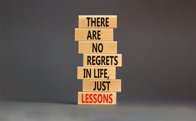 Regrets or lessons symbol. Concept words There are no regrets in life just lessons on wooden blocks...