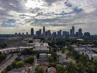 Fototapeta na wymiar an aerial shot of the skyscrapers and office buildings in the city skyline with lush green trees and blue sky with powerful clouds at Frazier Park in Charlotte North Carolina USA