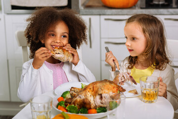 Wish you a happy Thanksgiving. The joyful children are sitting at the table. Traditional...