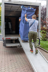 Professional mover carrying furniture