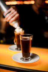 selective focus of latte glass with dark coffee drink
