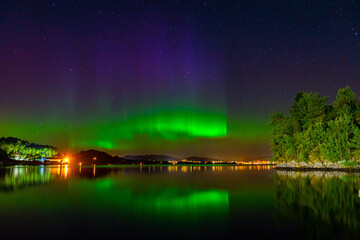 northern lights across the sea and mountains