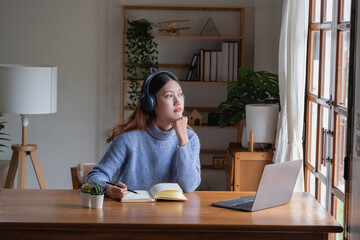 Relax, de-stress, vacation, have fun. Asian women take notes of their own past happily at home.