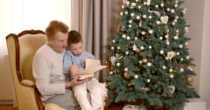 Senior woman with grandson near Christmas tree