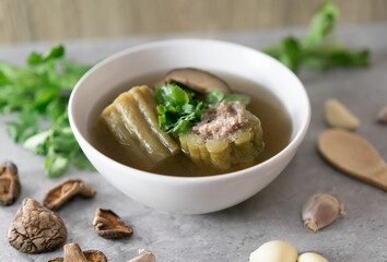Stuffed bitter gourd with seasoned minced pork soup Thai foods on white bowl