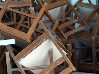 Recycling dump with trash of broken chairs, wooden chairs. pile of chairs.