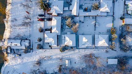 Aerial top view on cityscape covered with snow, appearance of the city in winter.