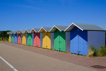 Eastbourne, East Sussex / United Kingdom - July 11 2022: Brightly coloured beach huts on Eastbourne...