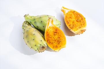 A fresh cut in half exotic tropical fruit pitaya or yellow dragon fruit on white background