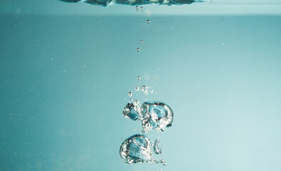 Clean bubbles inside water tank with blue in background closeup