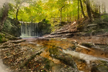 Epic beautiful Autumn landscape image of Nant Mill waterfall in Wales with glowing sunlight through the woodland