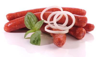 Raw Merguez Sausages with Onions isolated on white Background