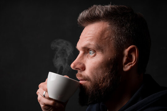 a man who marvels into the distance on a black background