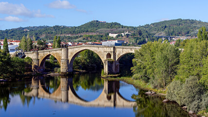 Fototapeta na wymiar Panoramic view of historic Roman bridge, or Old bridge, over river Miño in the city of Ourense, Galicia, Spain.