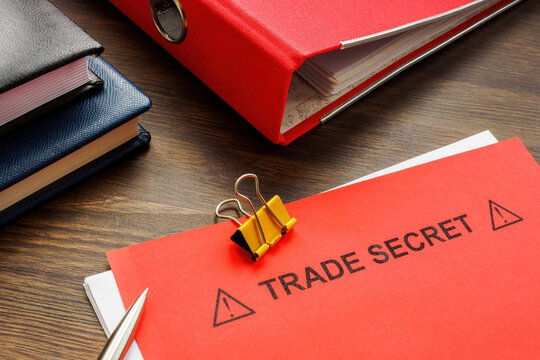 Papers With Trade Secret And A Red Folder.