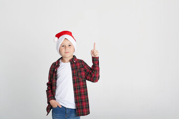 Cute little boy in the santa claus hat.