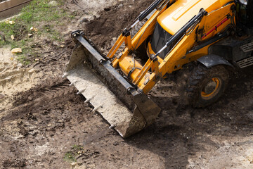 Earthwork bulldozer on the line. The work of a universal machine designed for digging soil, planning sites for construction, cleaning the territory, digging trenches. © Александр Ланевский