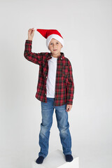 Cute little boy in the santa claus hat.