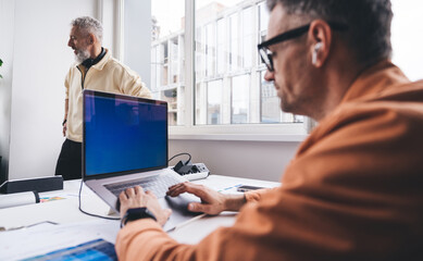 Male employee working on project with boss