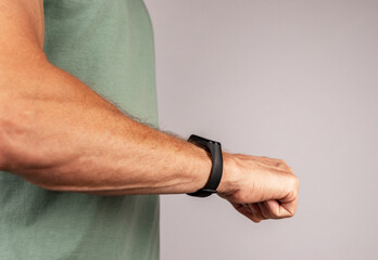 Using black smart fitness watch, bracelet on men hand. High quality photo