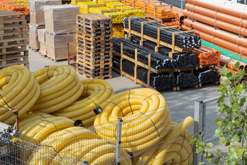 Slotted on store plumber tube and  huse protecting cables underground. Installations of Communications development, Large stock of PVC pipe tube and yellow  Coil Land Drainage flexible Pipe.